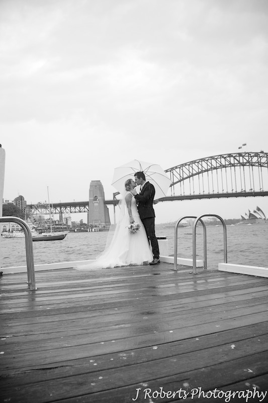 Couple kissing on a pier Sydney Harbour = wedding photography sydney